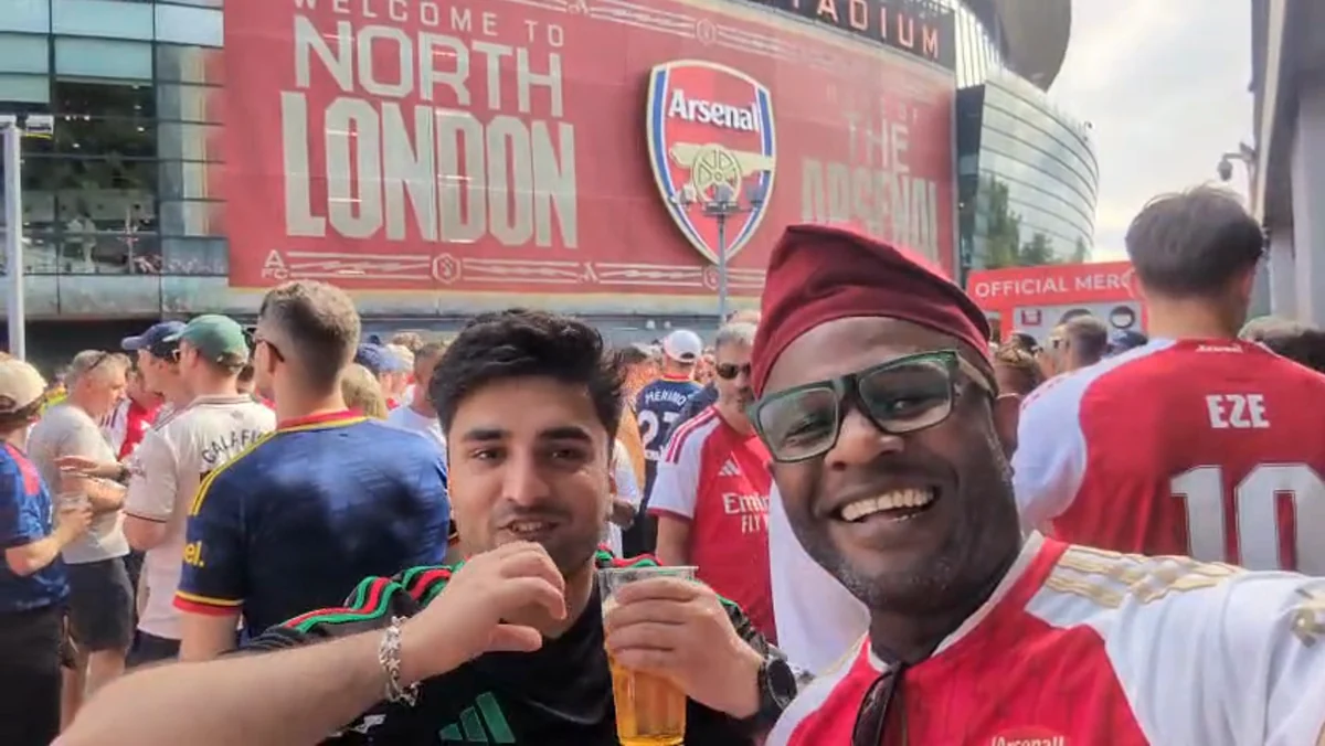 Ọlálékan and Cornitto smiling among supporters outside Emirates Stadium