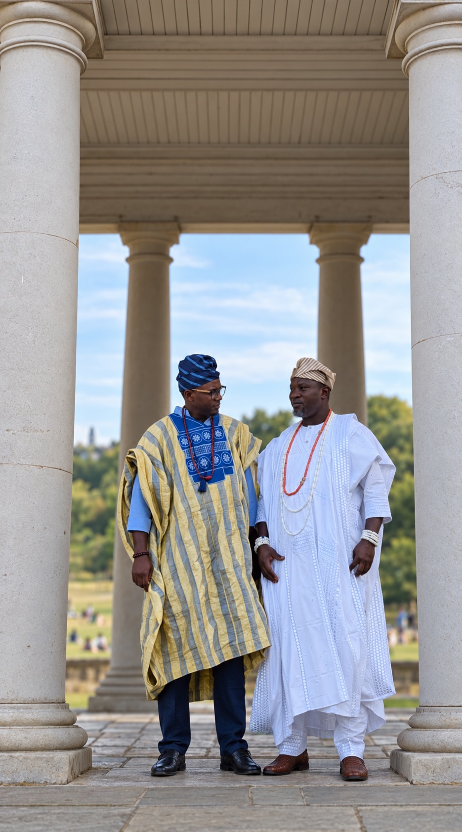 Ọlálékan Olúkọtún and Chief Babatunde Sanni in agbádá standing together between columns at Royal Greenwich