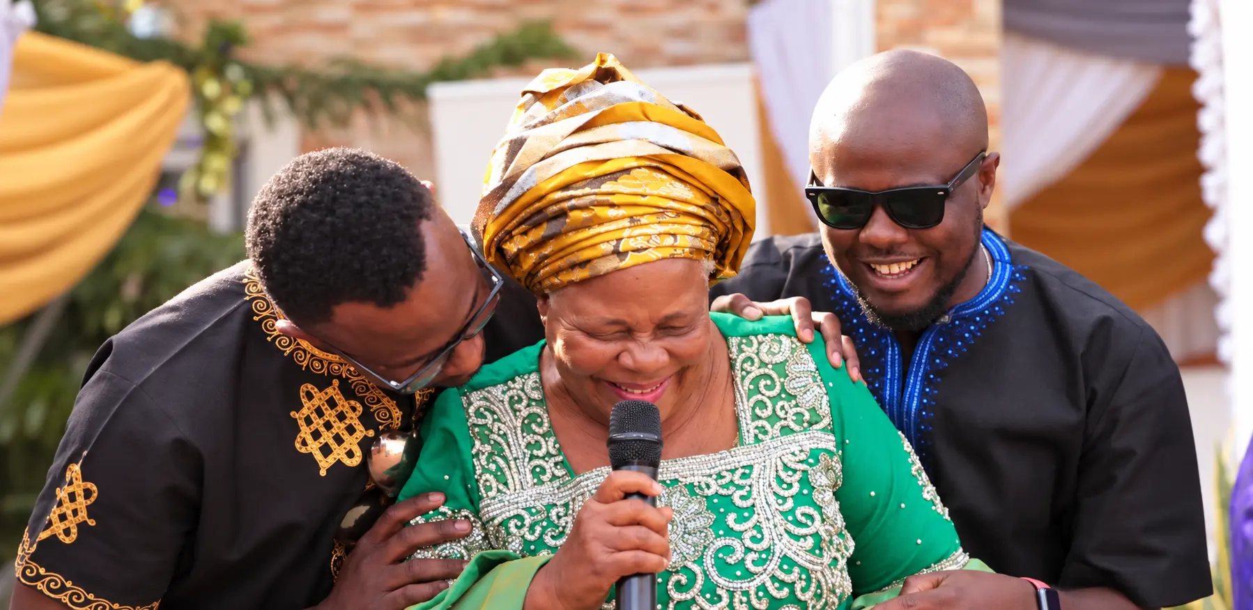 Betty Nnenna Nwakaego smiling with a microphone at her 70th birthday celebration in Abuja, 2018