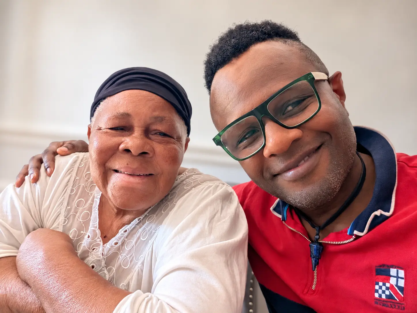 Ọlálékan smiling with his mother, Betty Nnenna Nwakaego, in London in 2026, his arm around her
