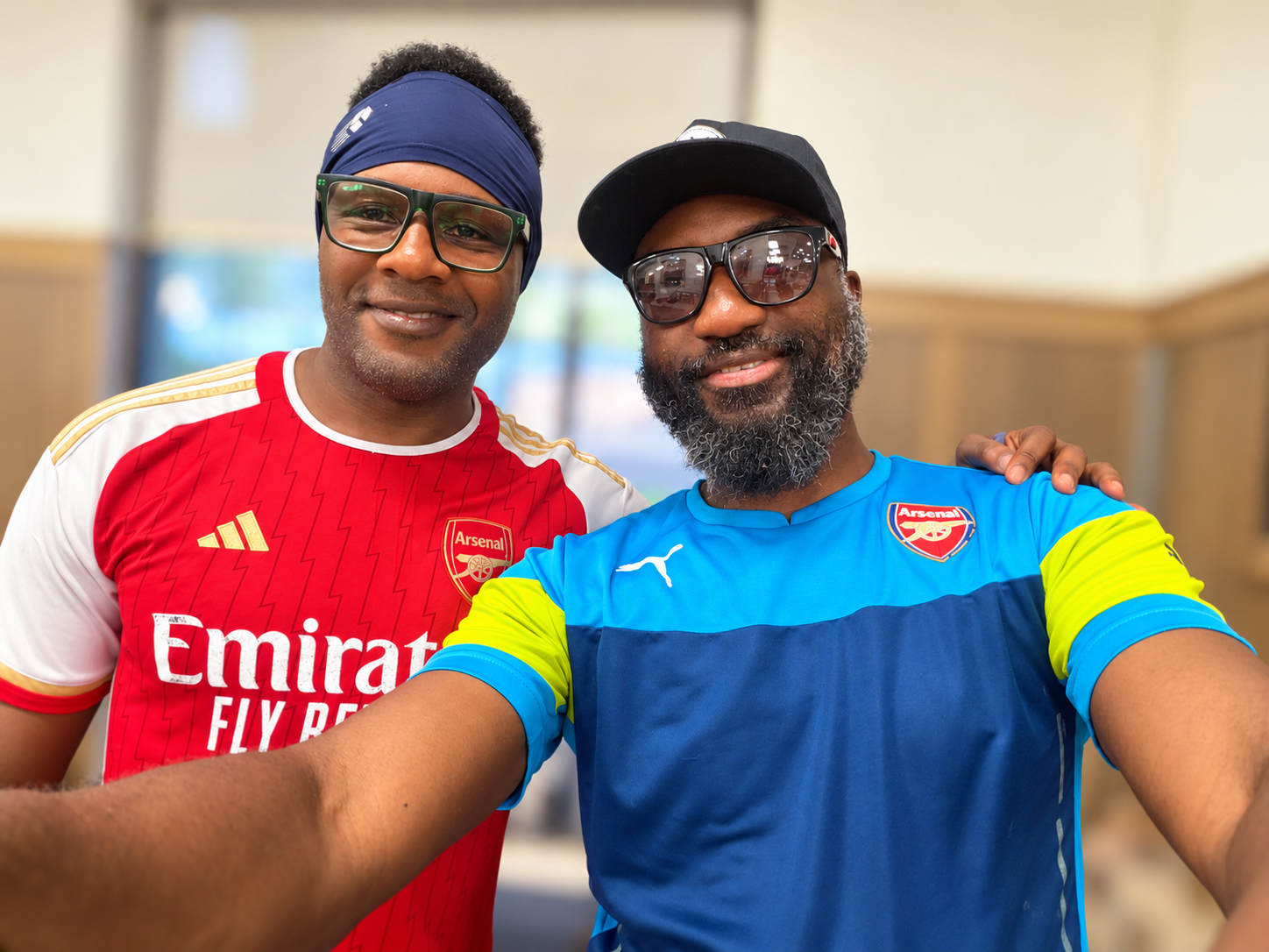 Ọlálékan and his friend Dr Tokunbo Tijani in Arsenal kit during a June 2026 visit